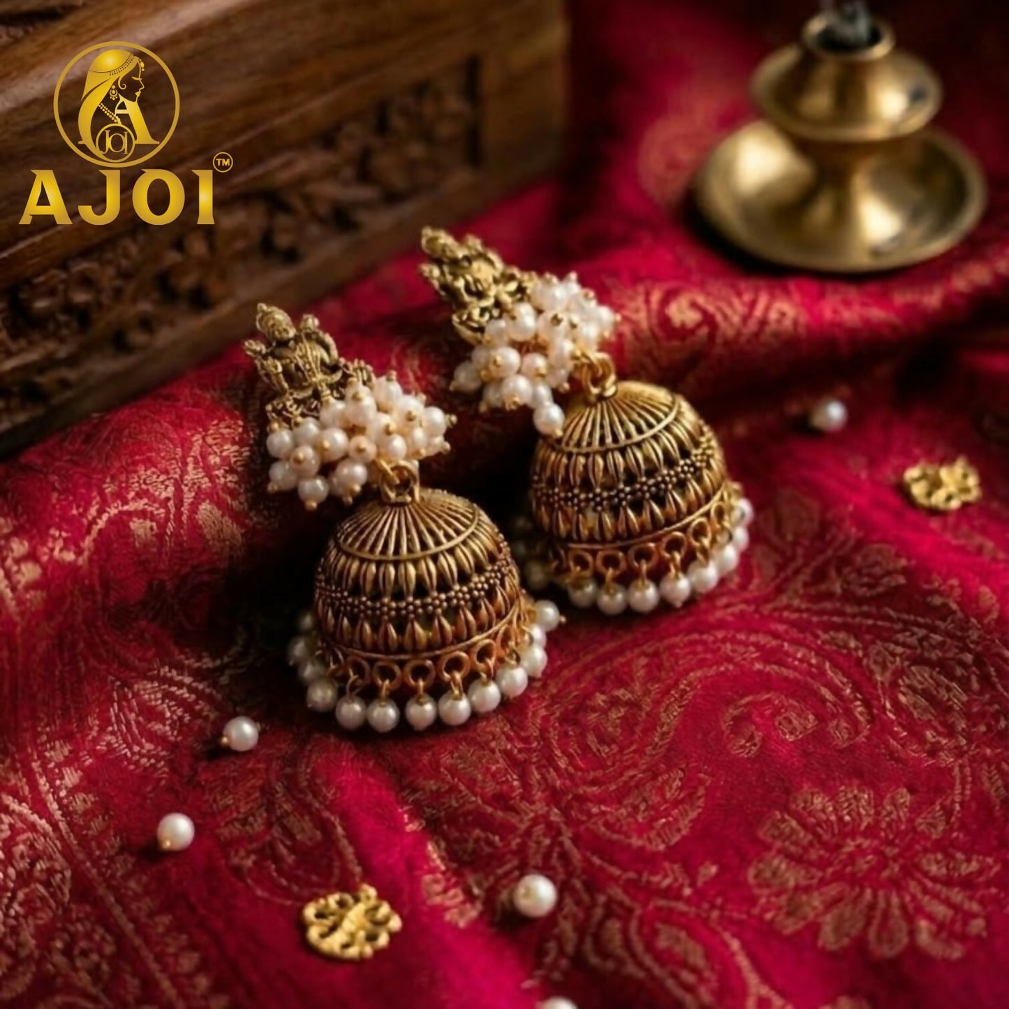 Antique gold jhumka earrings showcasing intricate temple design