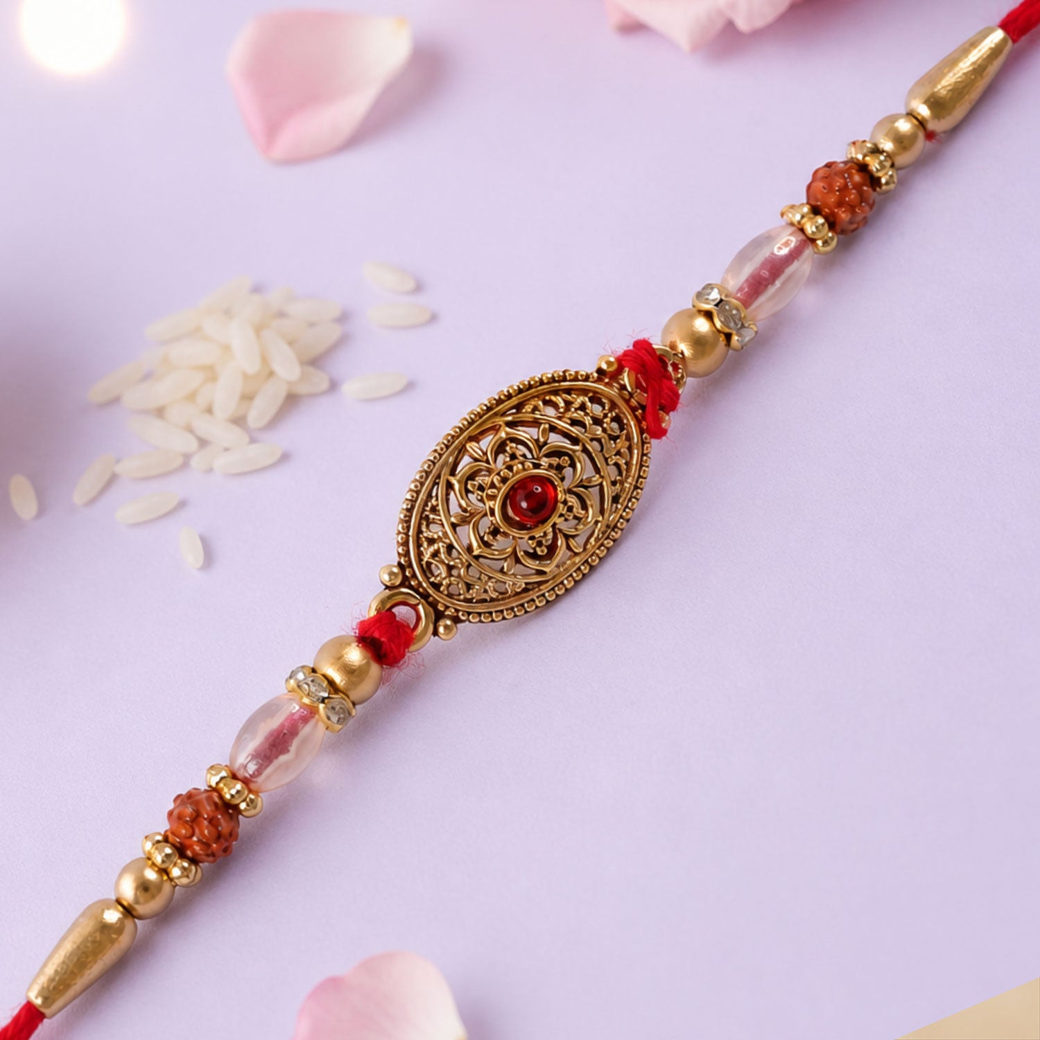 Oxidized Gold Oval Pendant Rakhi with Red Stone and Rudraksha Beads