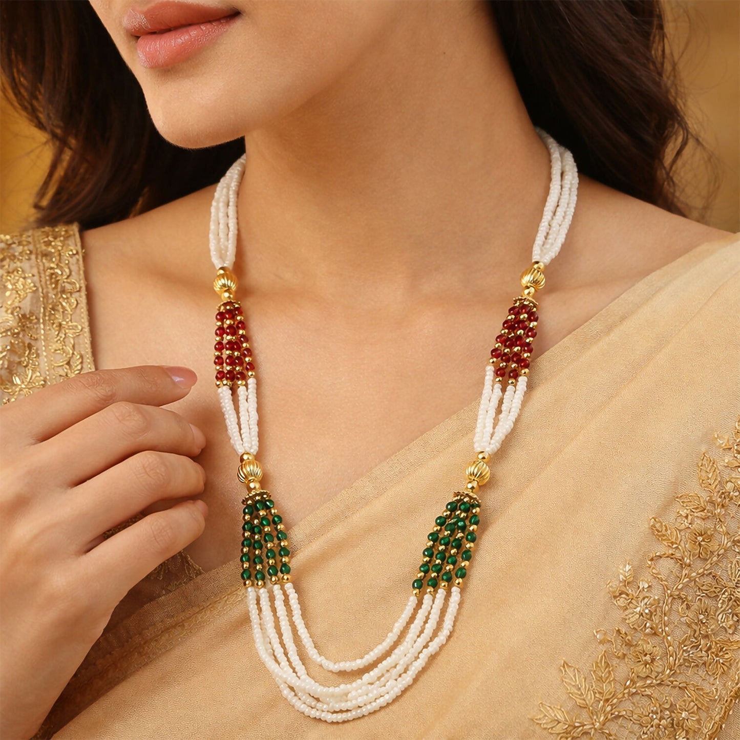 Close-up of red and green accent beads on traditional mala necklace