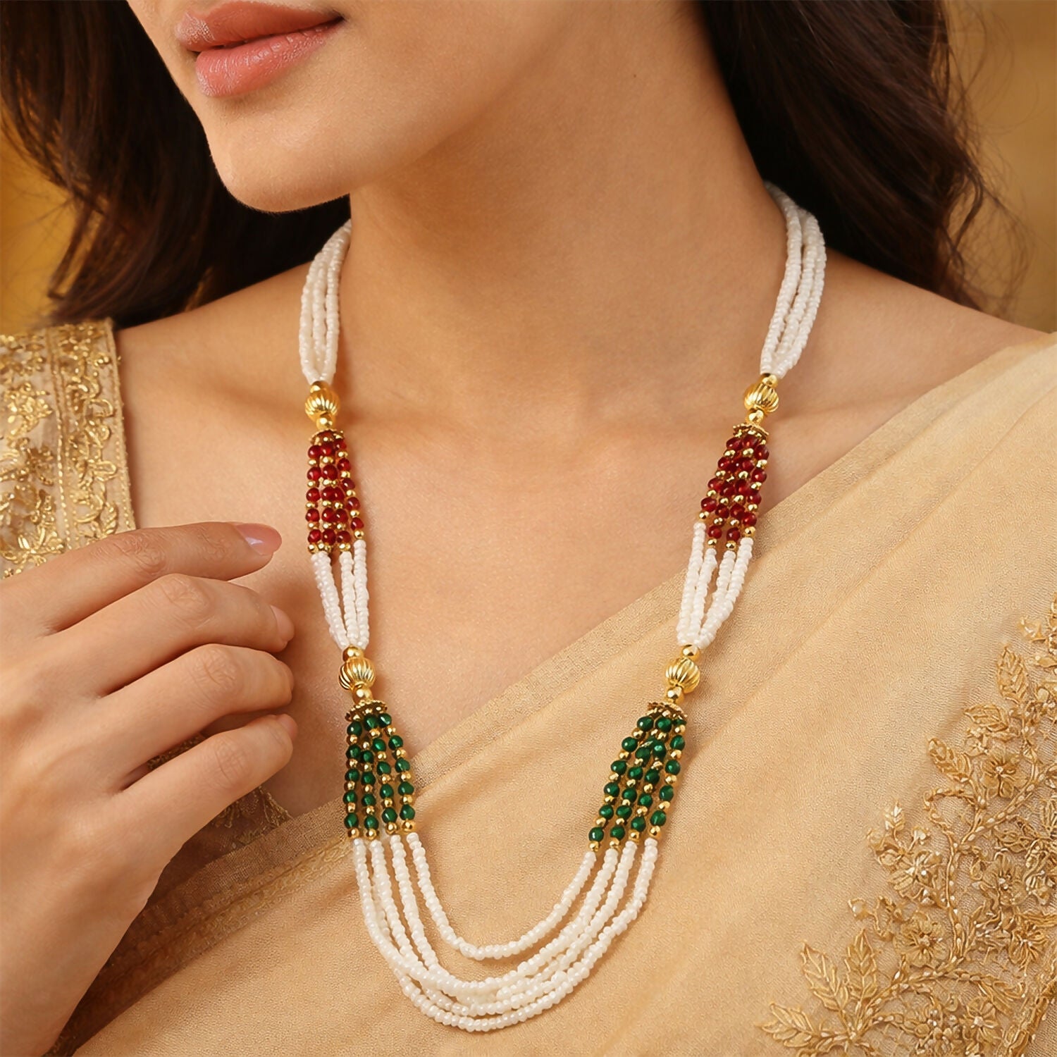Close-up of red and green accent beads on traditional mala necklace