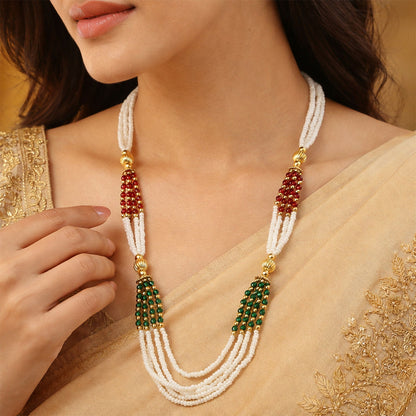 Close-up of red and green accent beads on traditional mala necklace