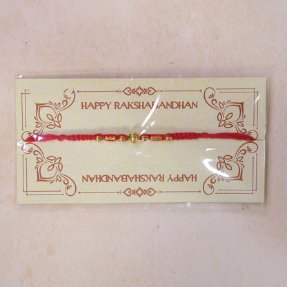 Red Braided Rakhi with a Row of Smooth Golden Bead Accents