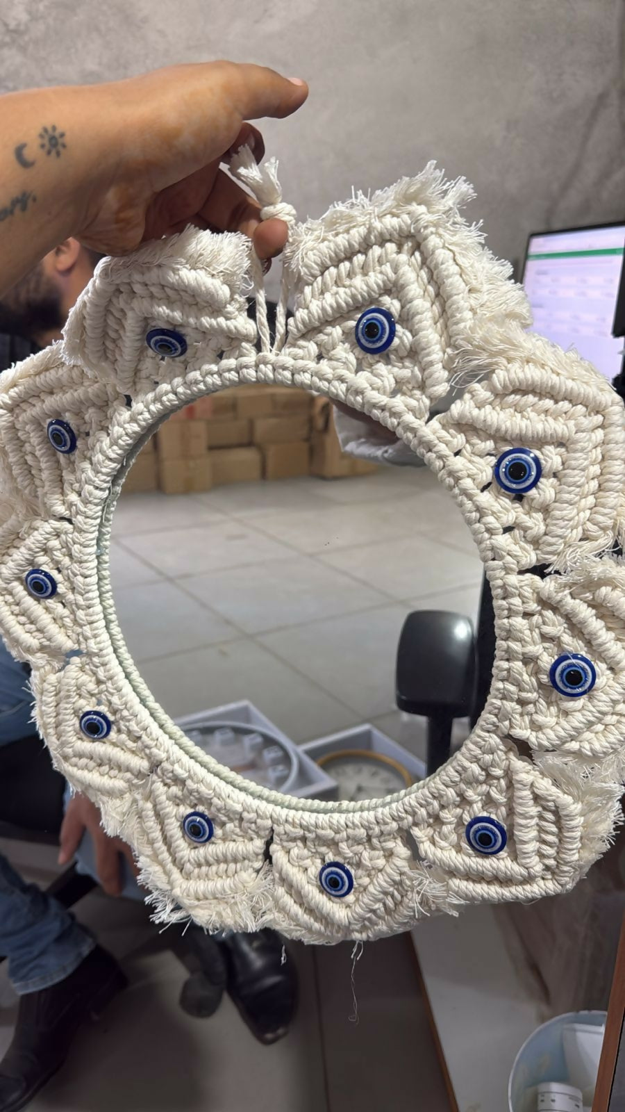 Macrame wall mirror displayed in modern home setting