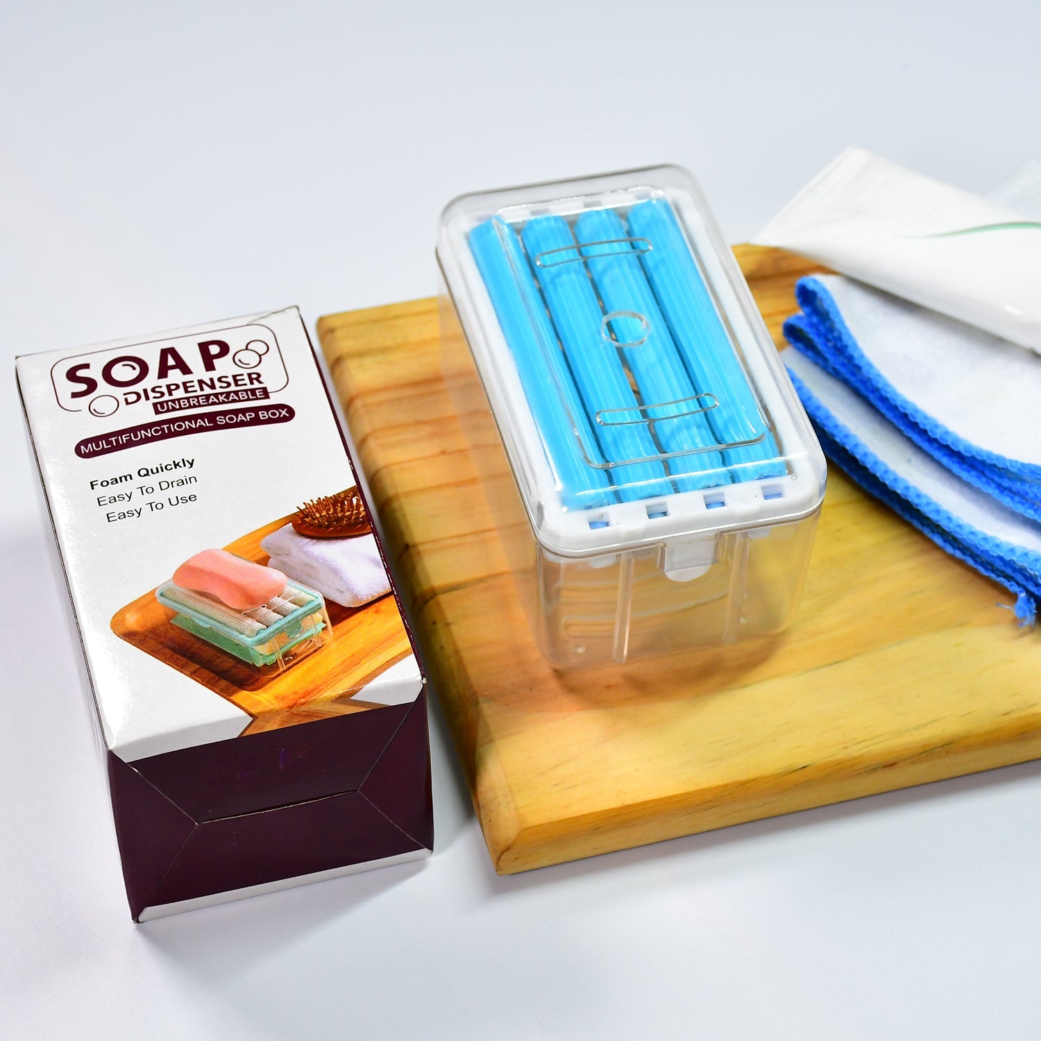 Portable soap dish with roller and drainage for effective soap management