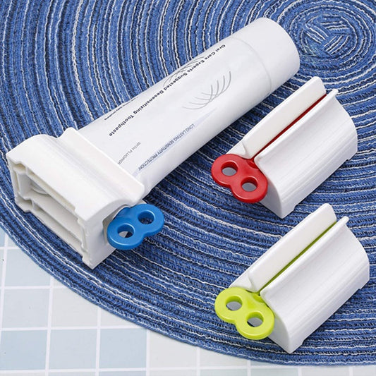 Stand for toothpaste tubes with built-in rolling squeezer