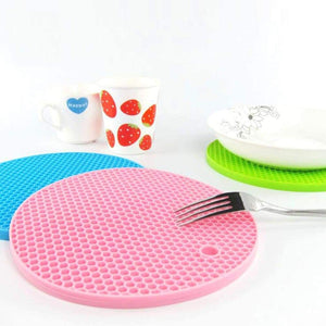 Silicone hot mat designed to protect surfaces from hot cookware with a flexible material.