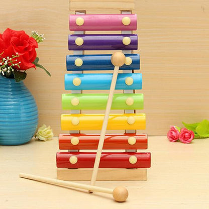 Multicolored wooden xylophone with mallet displayed on a surface