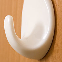 Adhesive hooks in packaging